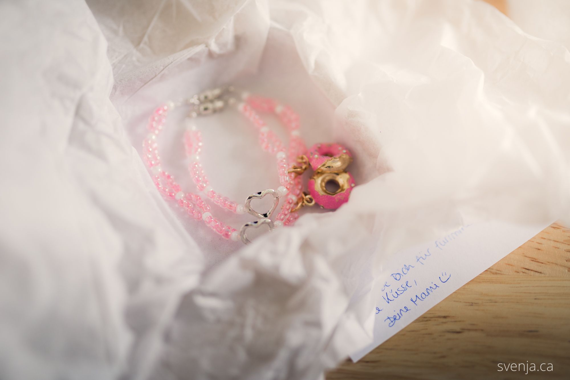 two pink bracelets lay in an opened box