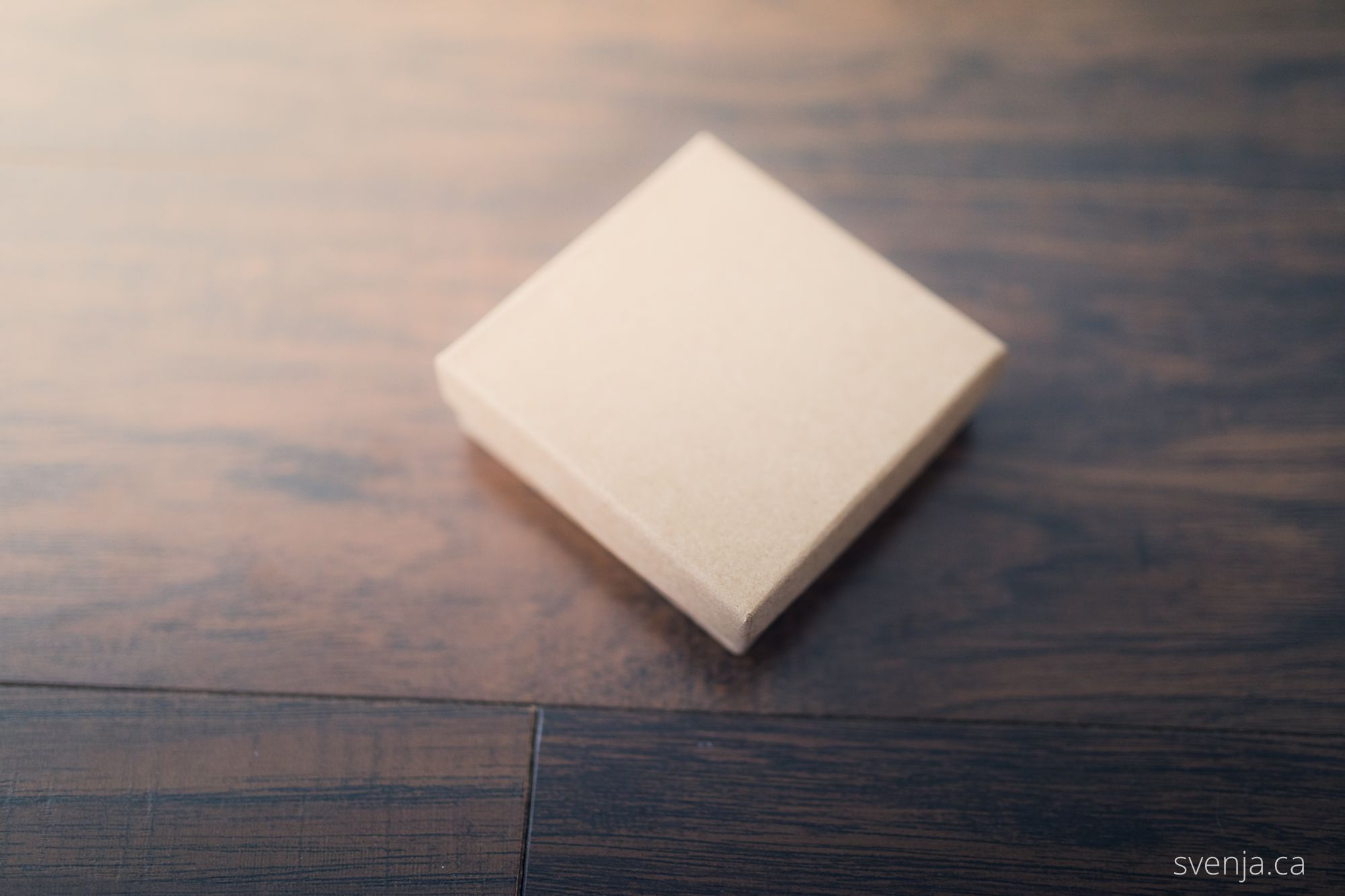 a box sits a hardwood floor