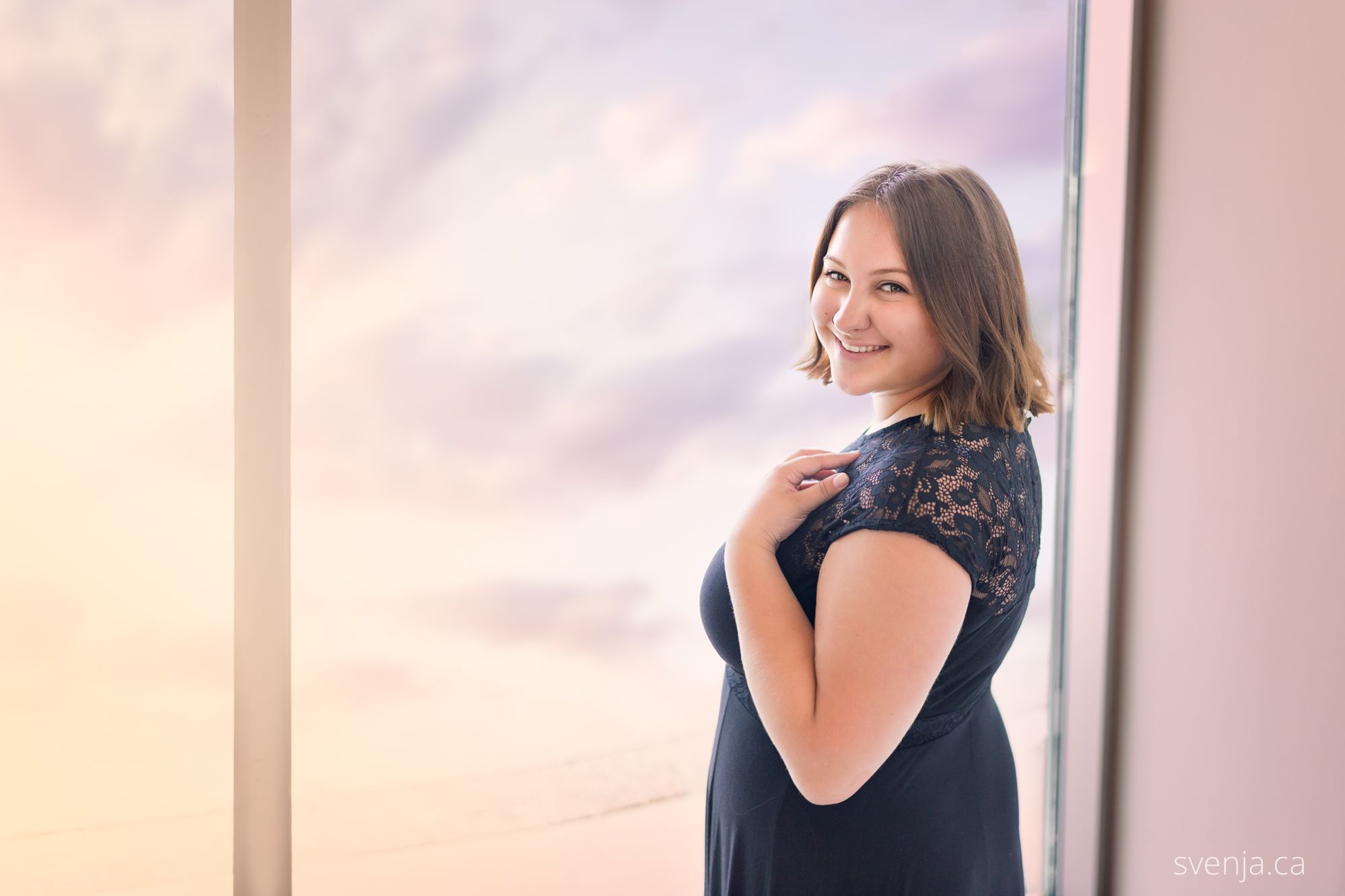 girl by window with pastel sky