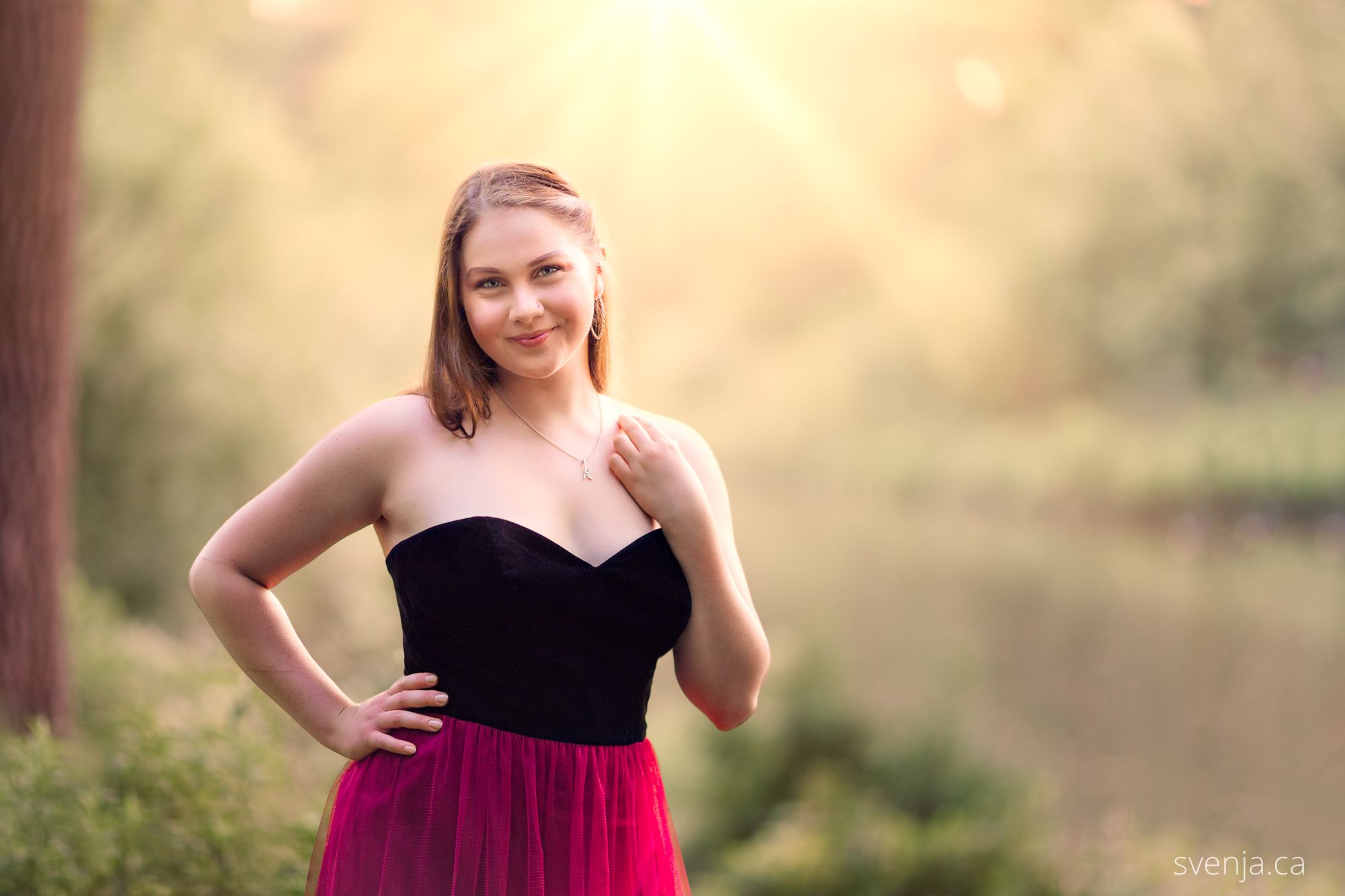 young woman in a dress with sunlight coming in from behind her