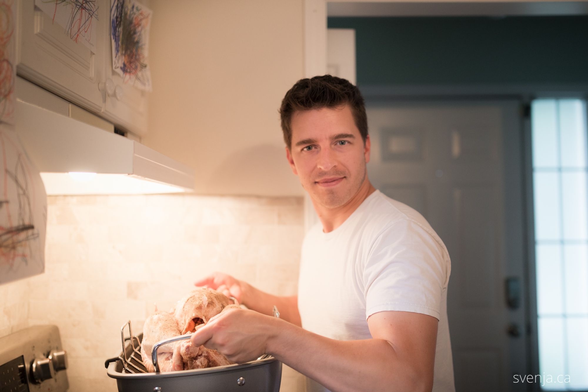 man holding a turkey on a turkey rack