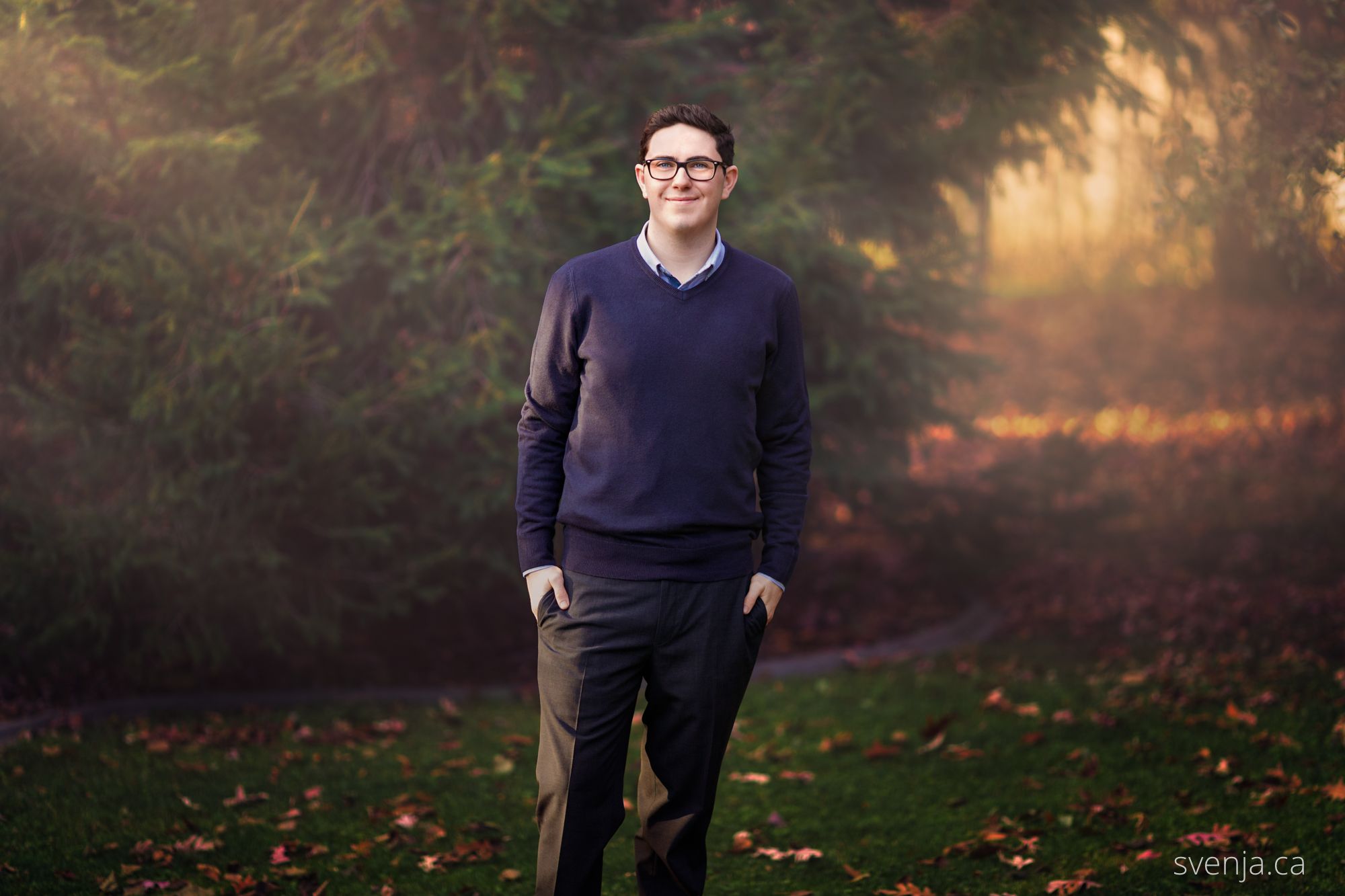 portrait of man standing in front of forest